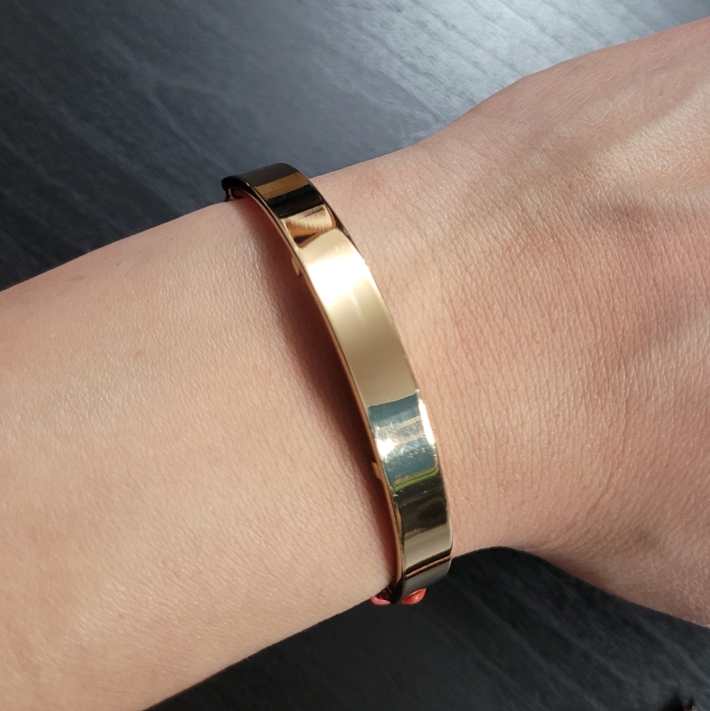 Gold bar bracelet, orange leather strap.